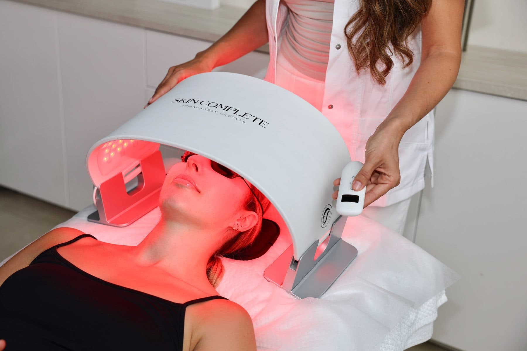 LED therapy with red light on the face, in the treatment room